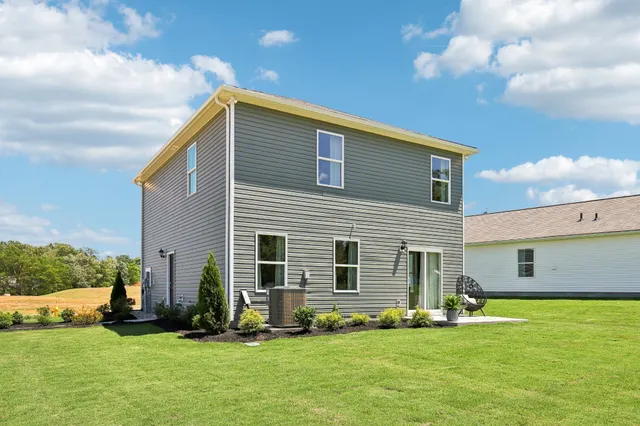 a house view with a garden and chair