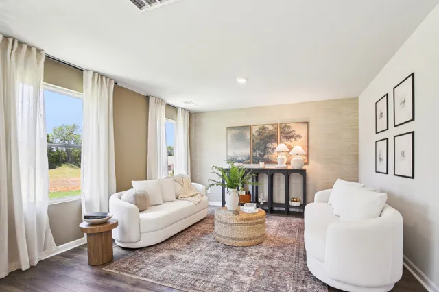 a living room with furniture and a large window