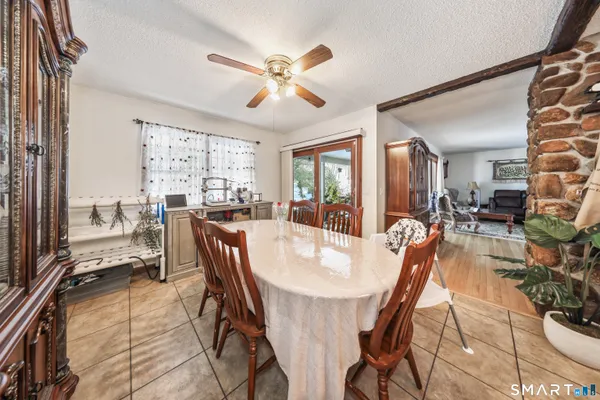 a dining room with furniture a chandelier and a rug