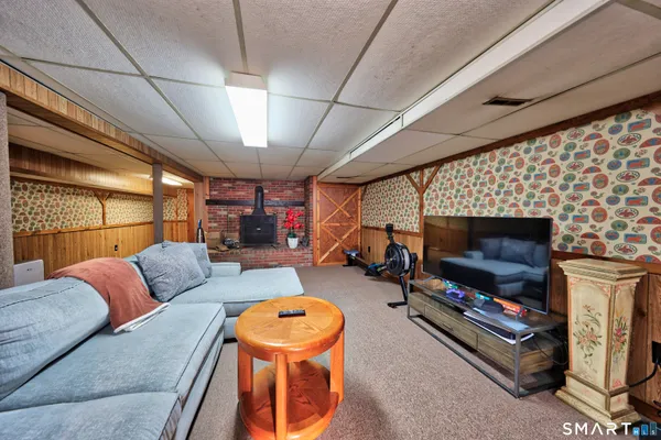 a living room with furniture a flat screen tv and a fireplace