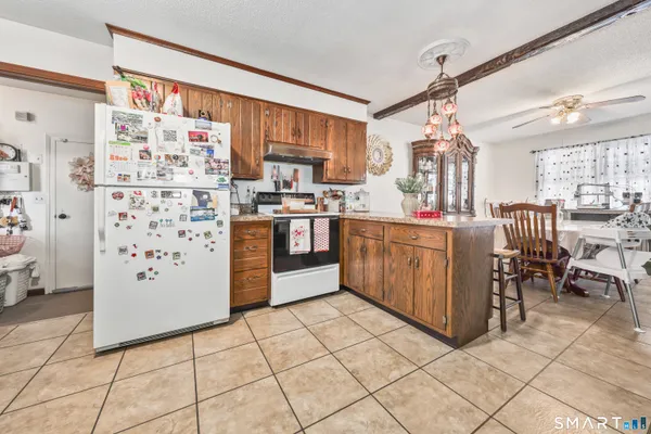 a kitchen with stainless steel appliances a stove a sink and a refrigerator