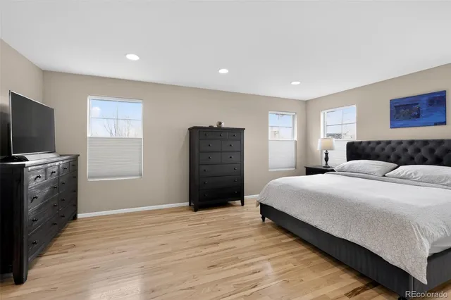 a bedroom with a bed and a television