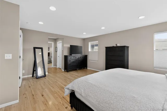 a large bedroom with bed and tv