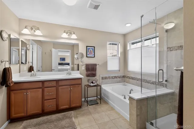 a bathroom with a tub sink and mirror