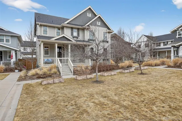 a view of a white house with a large windows next to a road