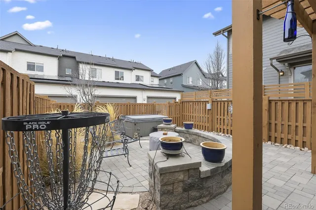 a view of a patio with chairs and potted plants on wall