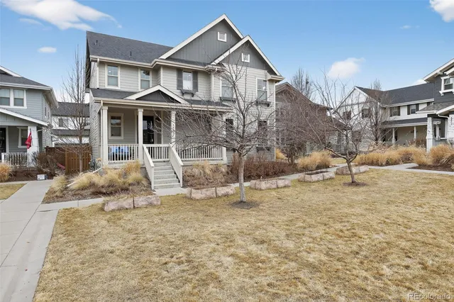 a view of a white house with a large windows next to a road