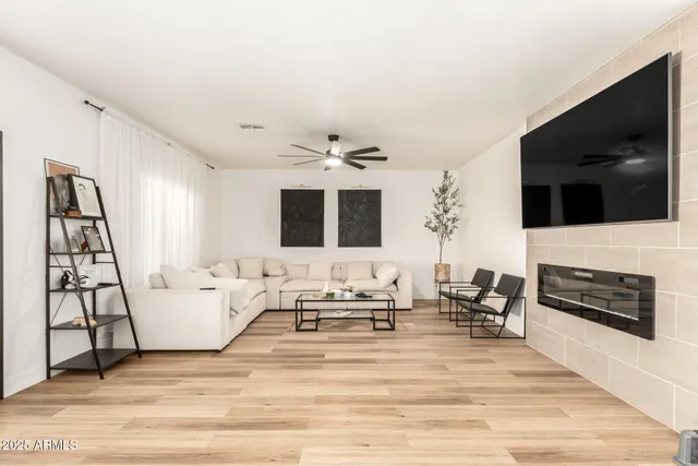 a living room with furniture and wooden floor