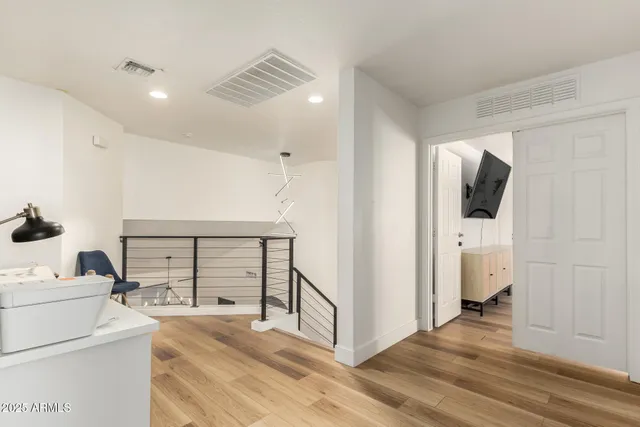 a spacious bedroom with a bed and a chandelier