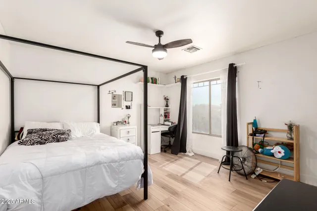 a bedroom with a bed and a chair