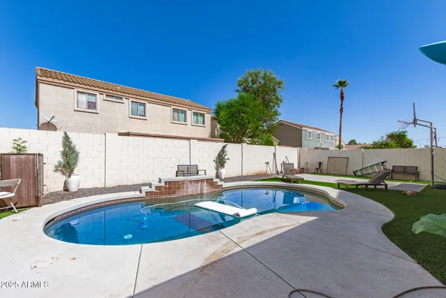 a front view of house with yard and swimming pool
