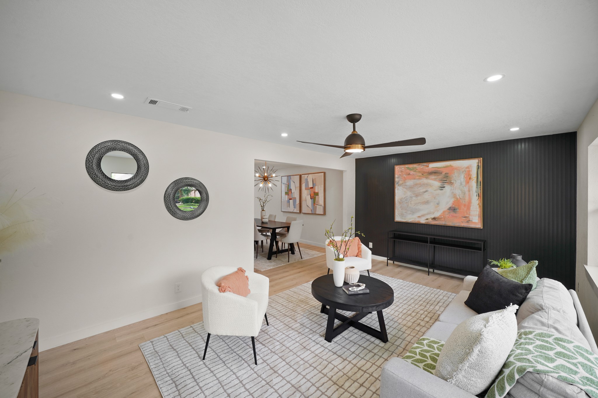 4813 Hummingbird Street Houston, TX 77035 - Photo 4 of 50 The Living Area in the North Wing of the Home provides a Modern Open Concept! Featured Amenities include Wide Plank White Oak Hued Engineered Floors and an Onyx Paneled Bead Board Accent Wall.