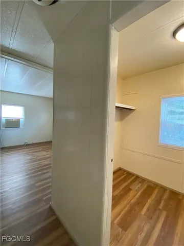 a view of a room with wooden floor