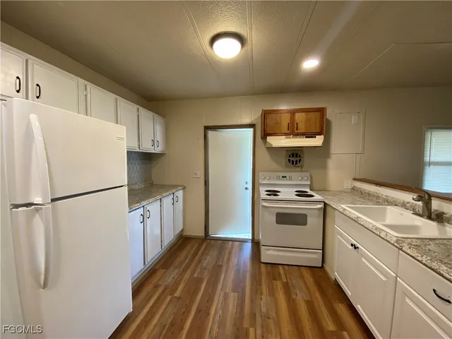 a kitchen with a refrigerator a sink and dishwasher