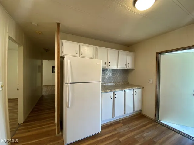 a white refrigerator freezer sitting in a kitchen