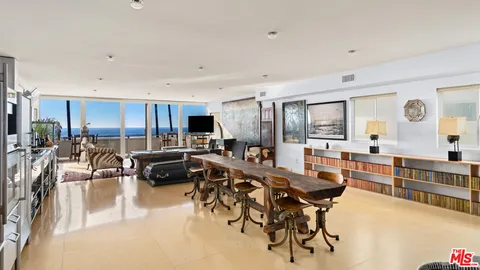 a view of a dining room kitchen with furniture and a large window