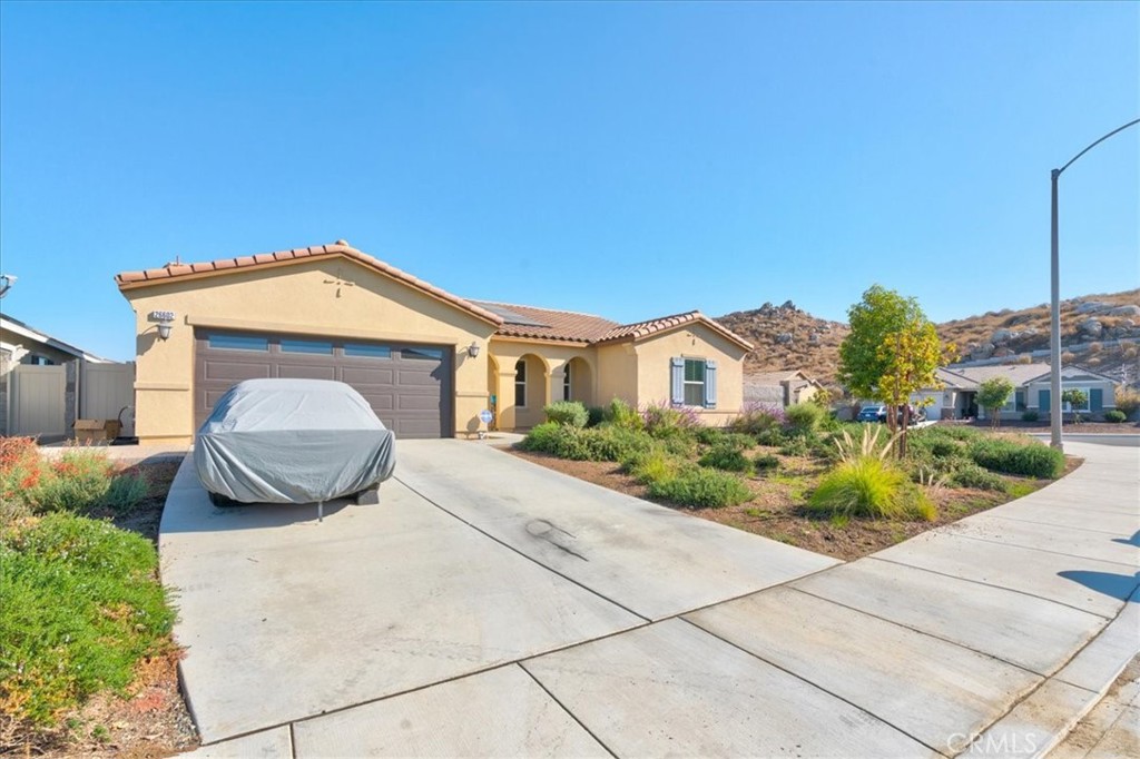 26602 C. Cantera Menifee, CA 92585 - Photo 2 of 14 a front view of a house with a garden and plants