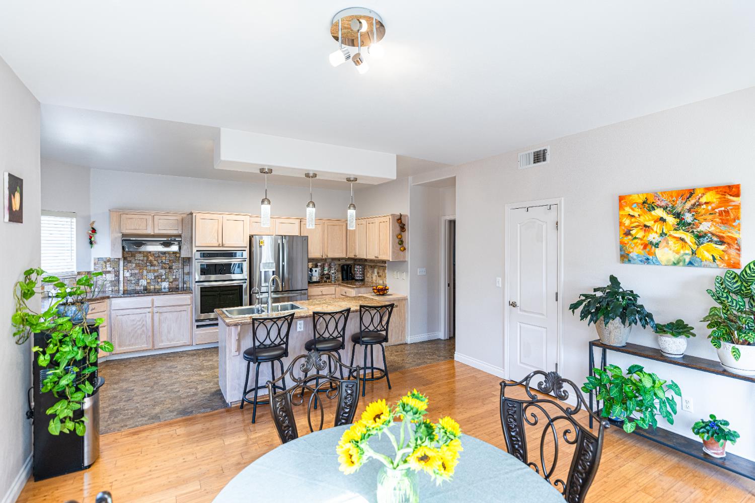 2322 East Revere Road Fresno, CA 93720 - Photo 13 of 33 an open kitchen with granite countertop a table and chairs in it