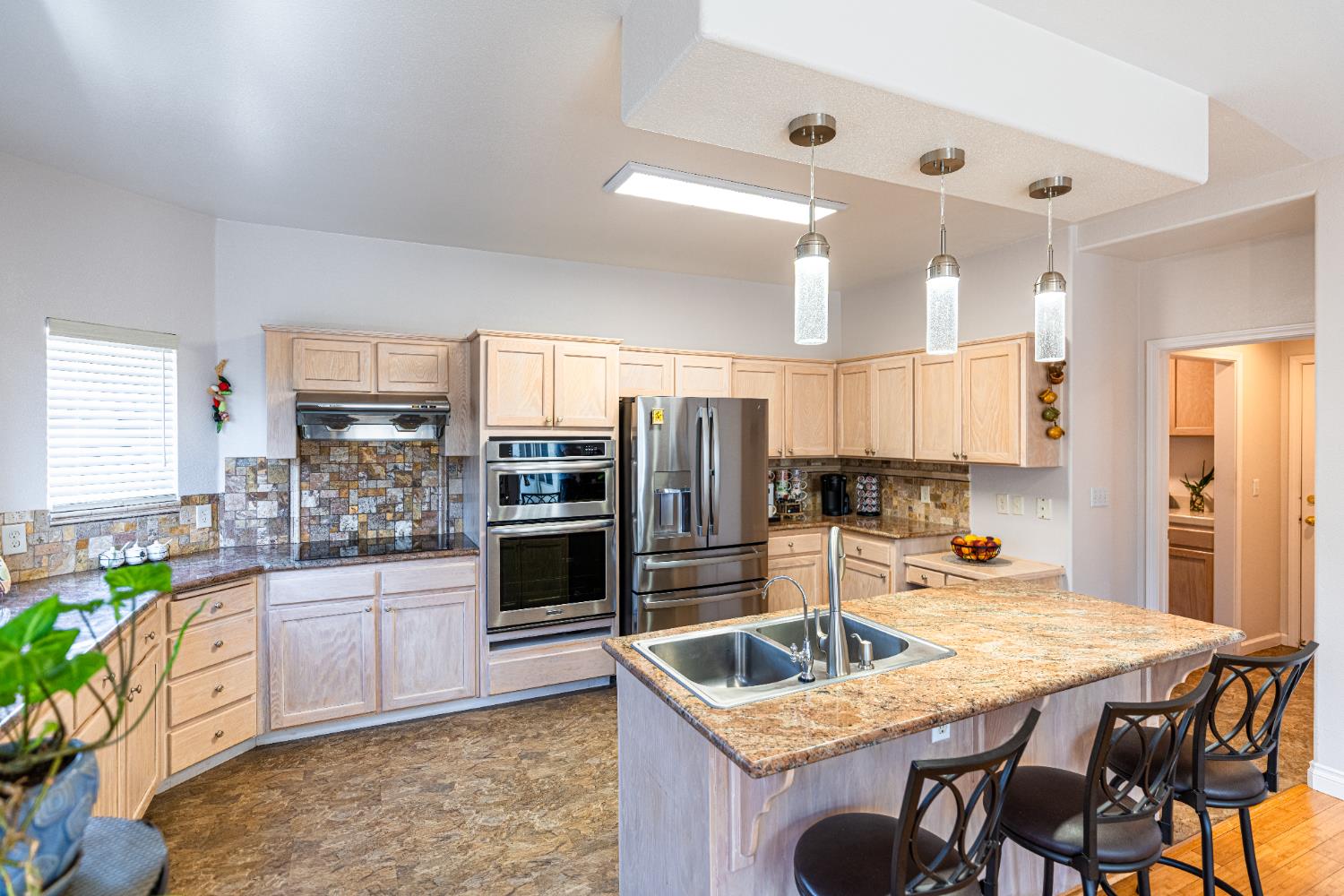 2322 East Revere Road Fresno, CA 93720 - Photo 14 of 33 a kitchen with stainless steel appliances granite countertop a sink refrigerator and cabinets