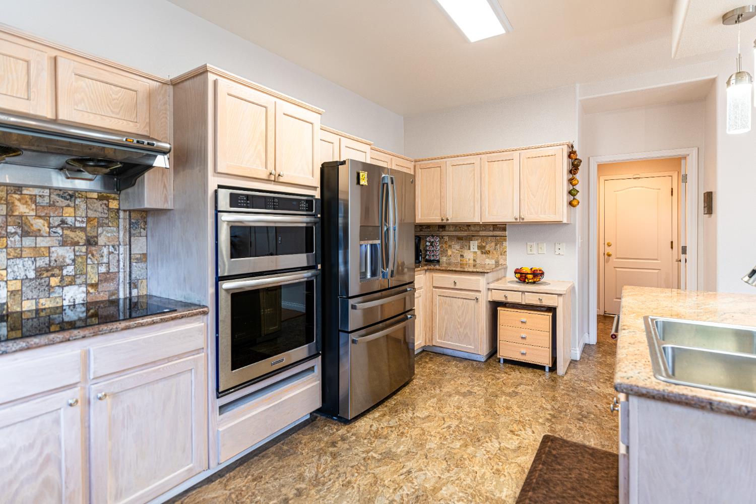 2322 East Revere Road Fresno, CA 93720 - Photo 16 of 33 a kitchen with granite countertop a refrigerator stove and sink