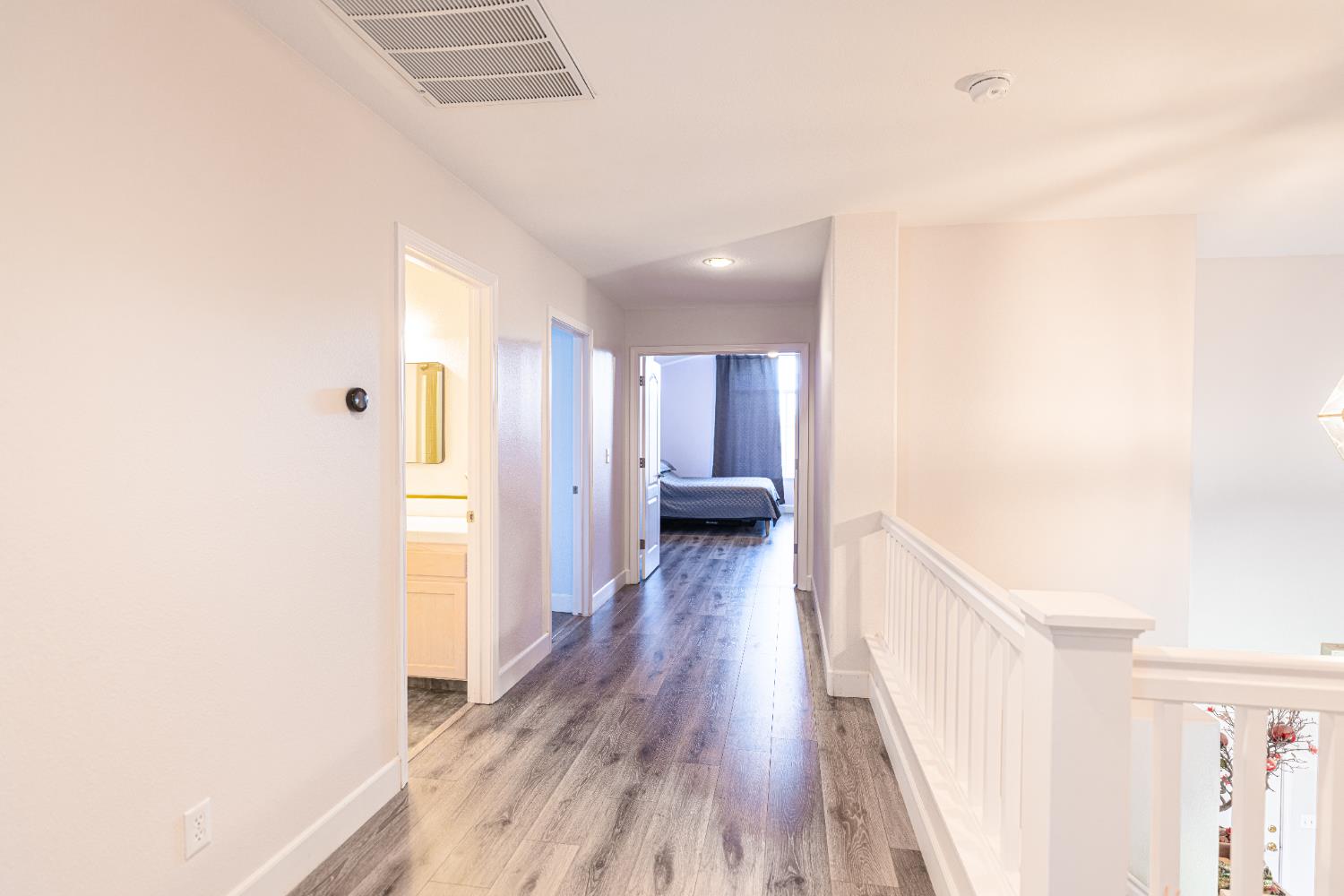 2322 East Revere Road Fresno, CA 93720 - Photo 19 of 33 a view of a hallway with wooden floor