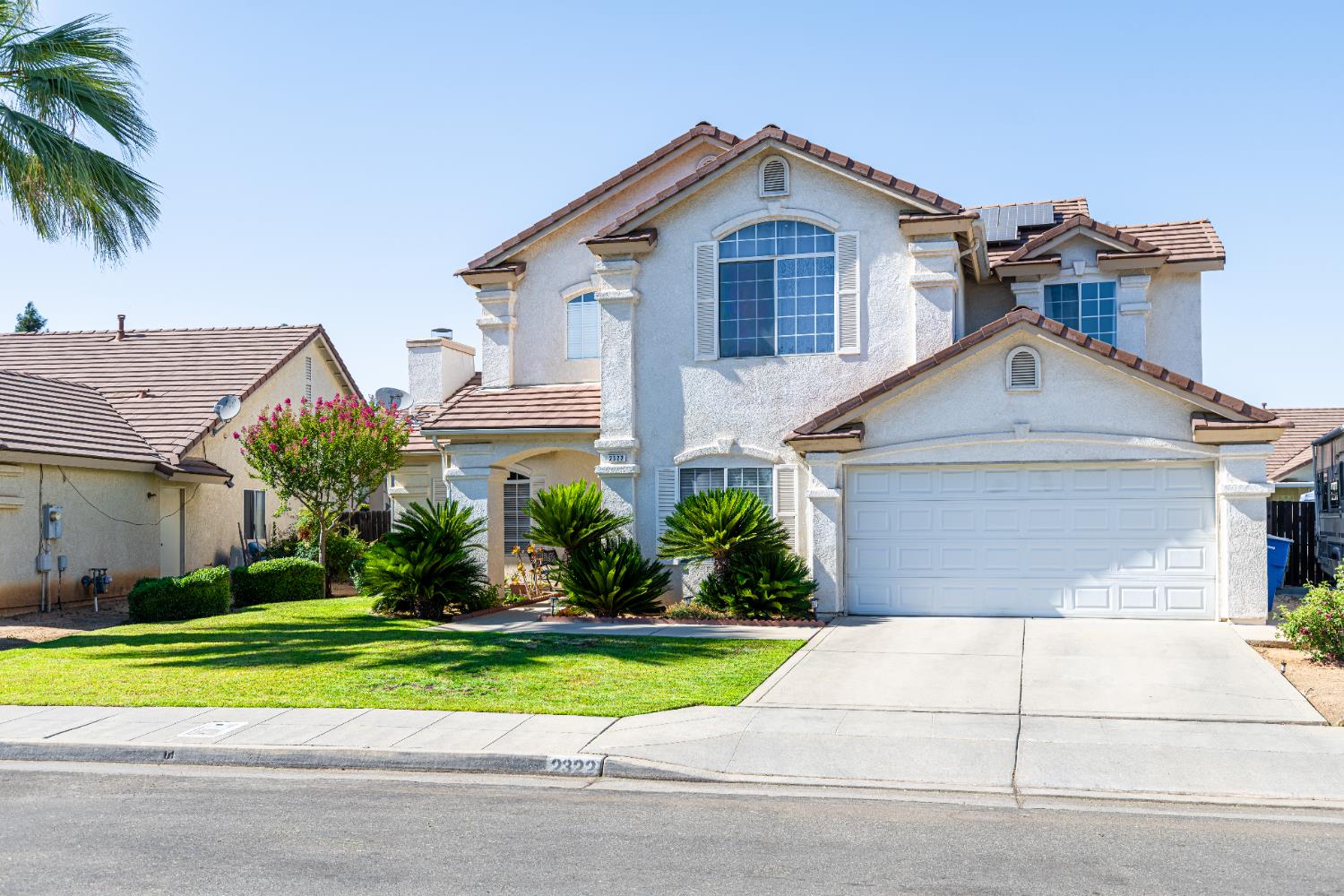 2322 East Revere Road Fresno, CA 93720 - Photo 2 of 33 a front view of a house with a yard and garage