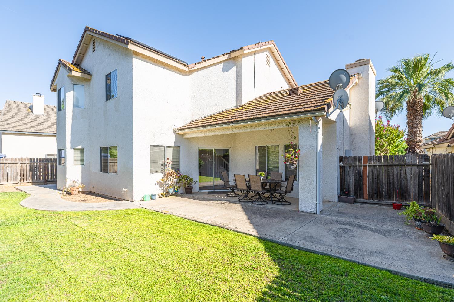 2322 East Revere Road Fresno, CA 93720 - Photo 26 of 33 a front view of house with yard outdoor seating and barbeque oven