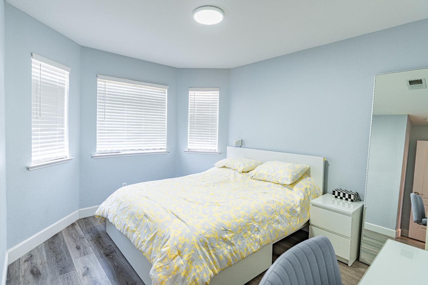 2322 East Revere Road Fresno, CA 93720 - Photo 28 of 33 a bedroom with a bed and a chair