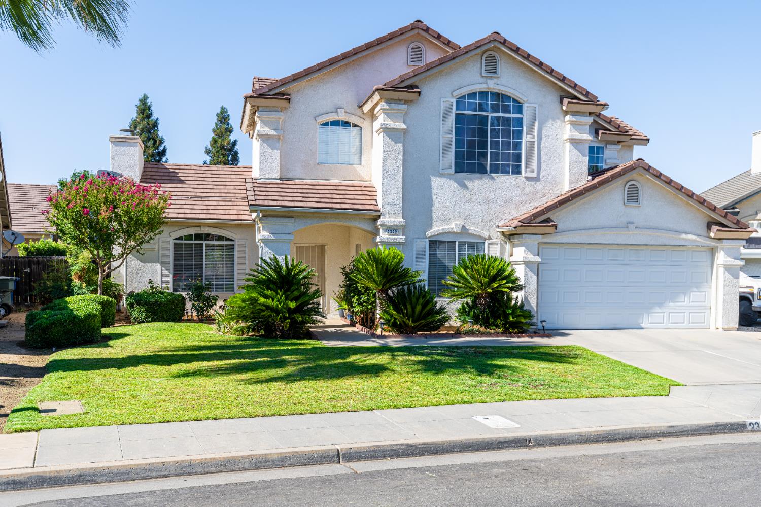 2322 East Revere Road Fresno, CA 93720 - Photo 3 of 33 a front view of a house with a yard and potted plants