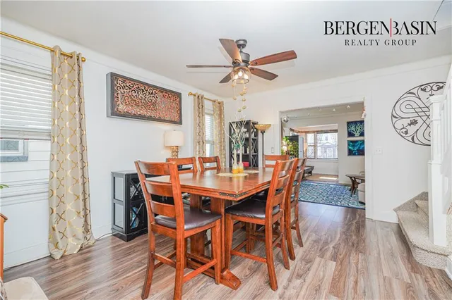 a dining room with furniture a rug and wooden floor