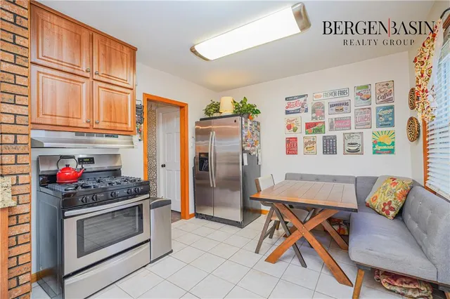 a kitchen with stainless steel appliances kitchen island granite countertop a refrigerator and a stove top oven