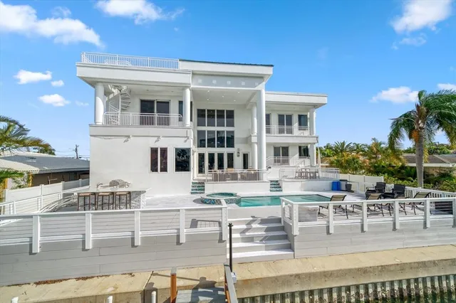 a view of a hallway with staircase and white walls