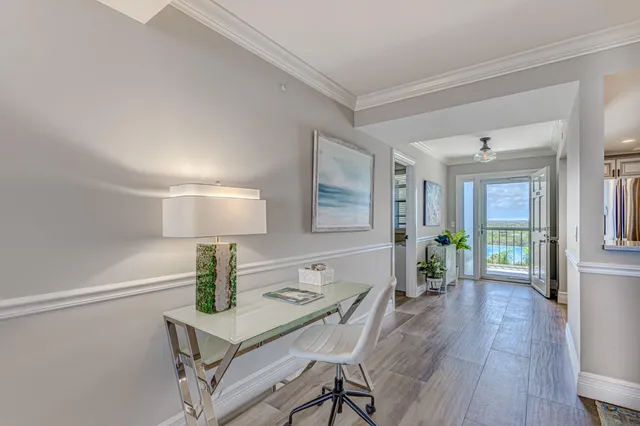 a living room with furniture and a floor to ceiling window