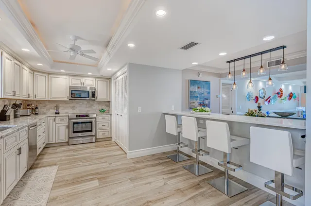 a living room with furniture and kitchen view