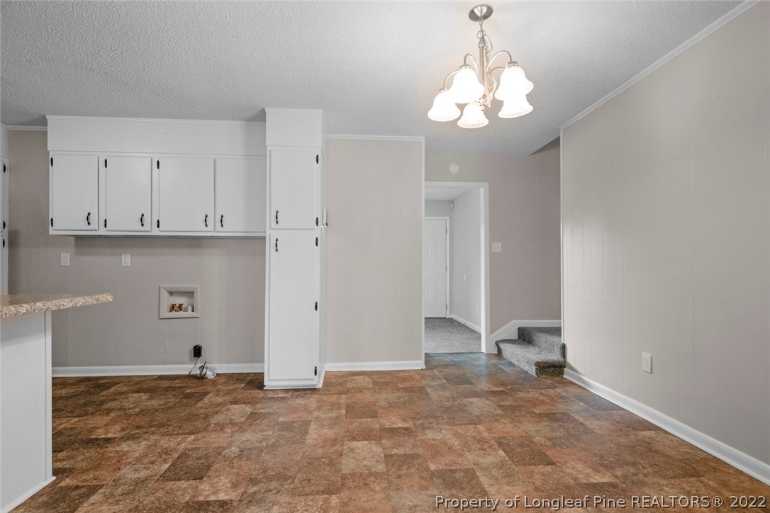 6614 Wake Forest Road Fayetteville, NC 28311 - Photo 15 of 48 a view of a livingroom with a chandelier