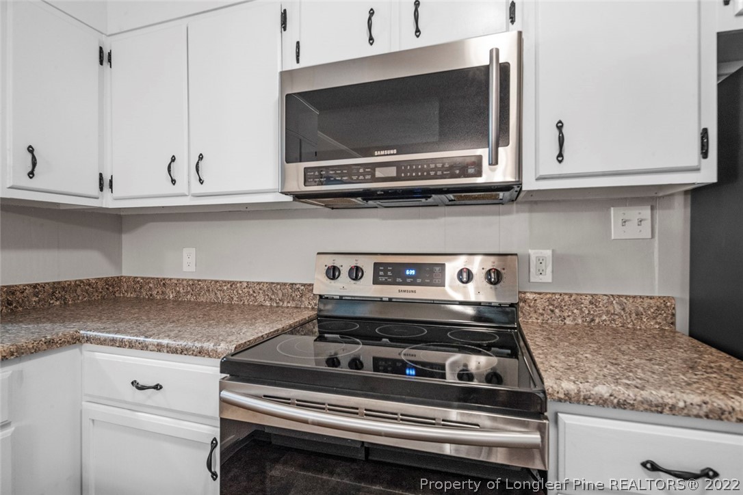 6614 Wake Forest Road Fayetteville, NC 28311 - Photo 20 of 48 a stove top oven sitting inside of a kitchen