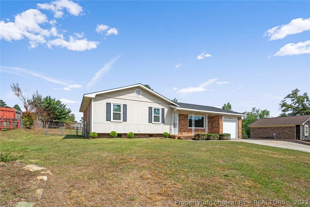 6614 Wake Forest Road Fayetteville, NC 28311 - Photo 2 of 48 a front view of a house with a garden