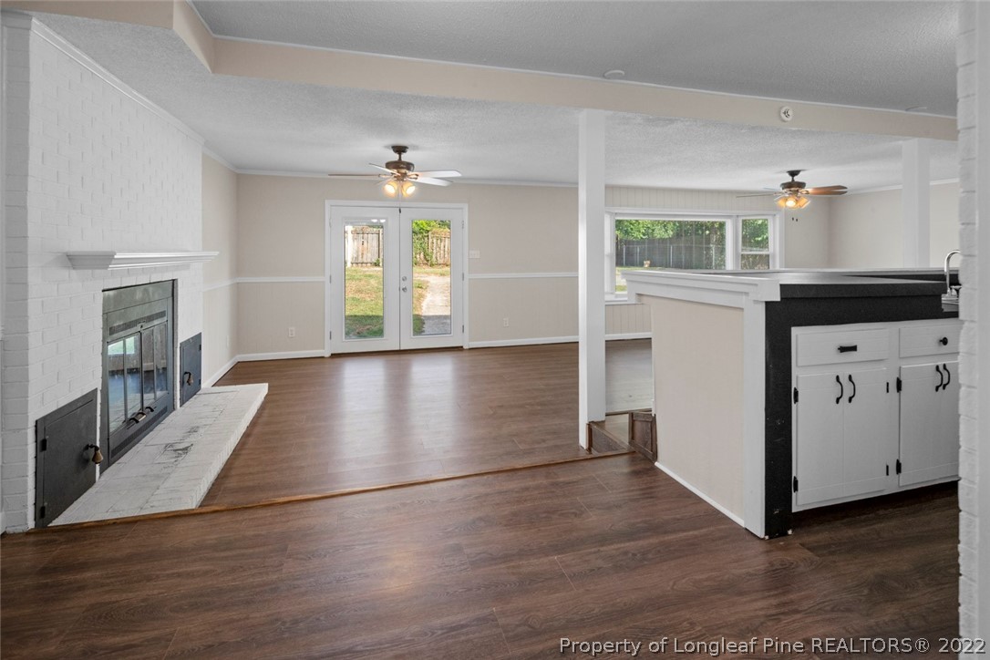 6614 Wake Forest Road Fayetteville, NC 28311 - Photo 24 of 48 a view of a hallway with wooden floor and a kitchen