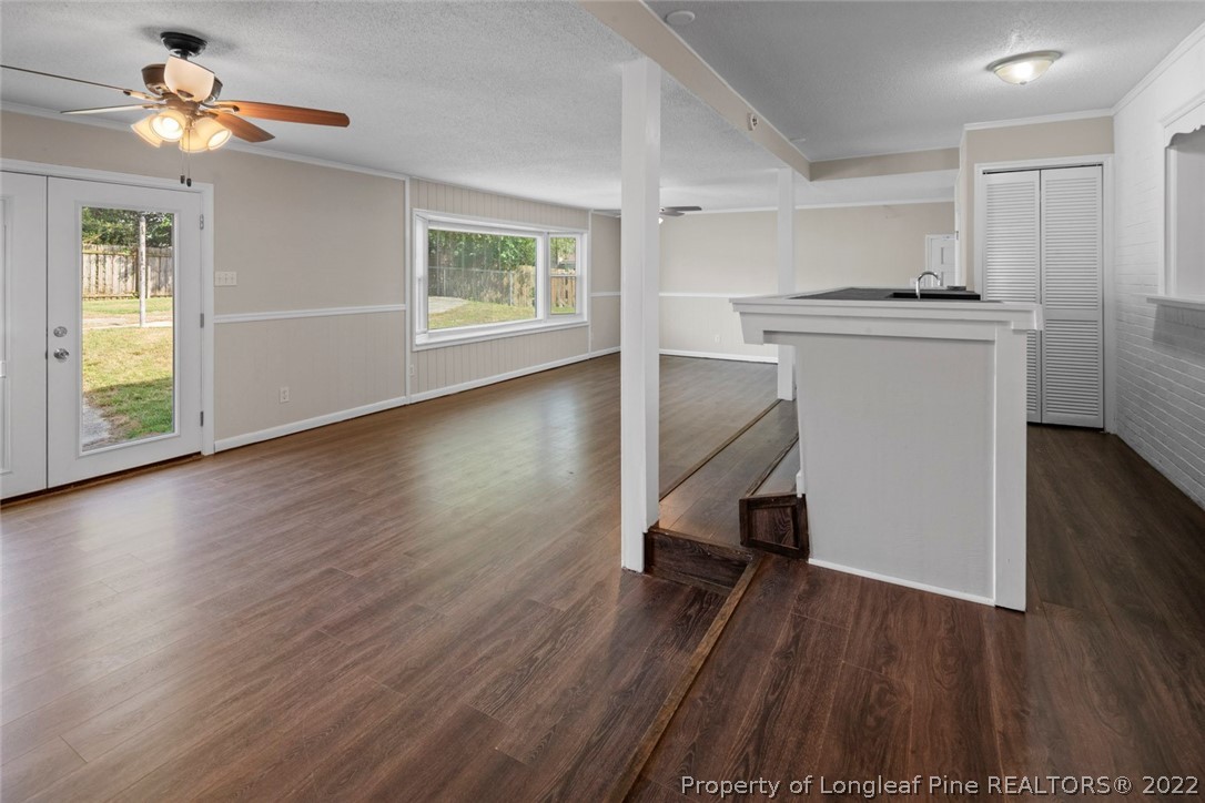 6614 Wake Forest Road Fayetteville, NC 28311 - Photo 25 of 48 a view of a kitchen with a fridge wooden floor and a window