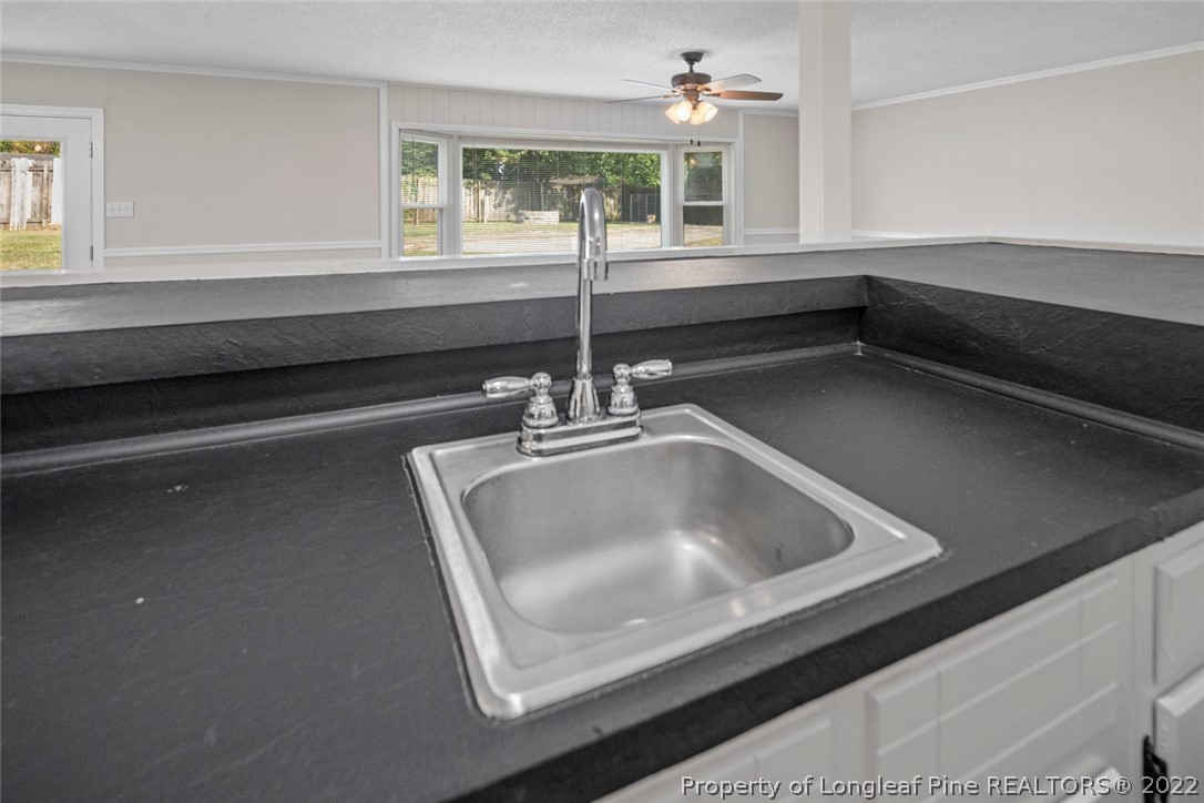 6614 Wake Forest Road Fayetteville, NC 28311 - Photo 27 of 48 a kitchen with a sink and a window