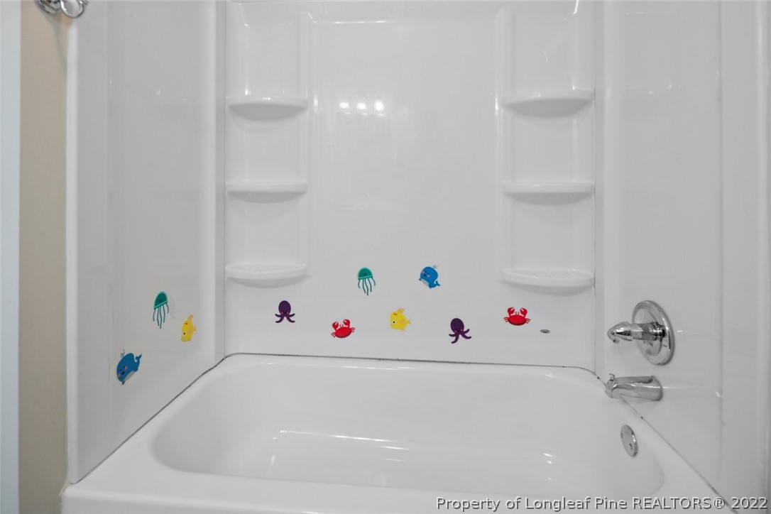 6614 Wake Forest Road Fayetteville, NC 28311 - Photo 32 of 48 a bathroom with a bathtub