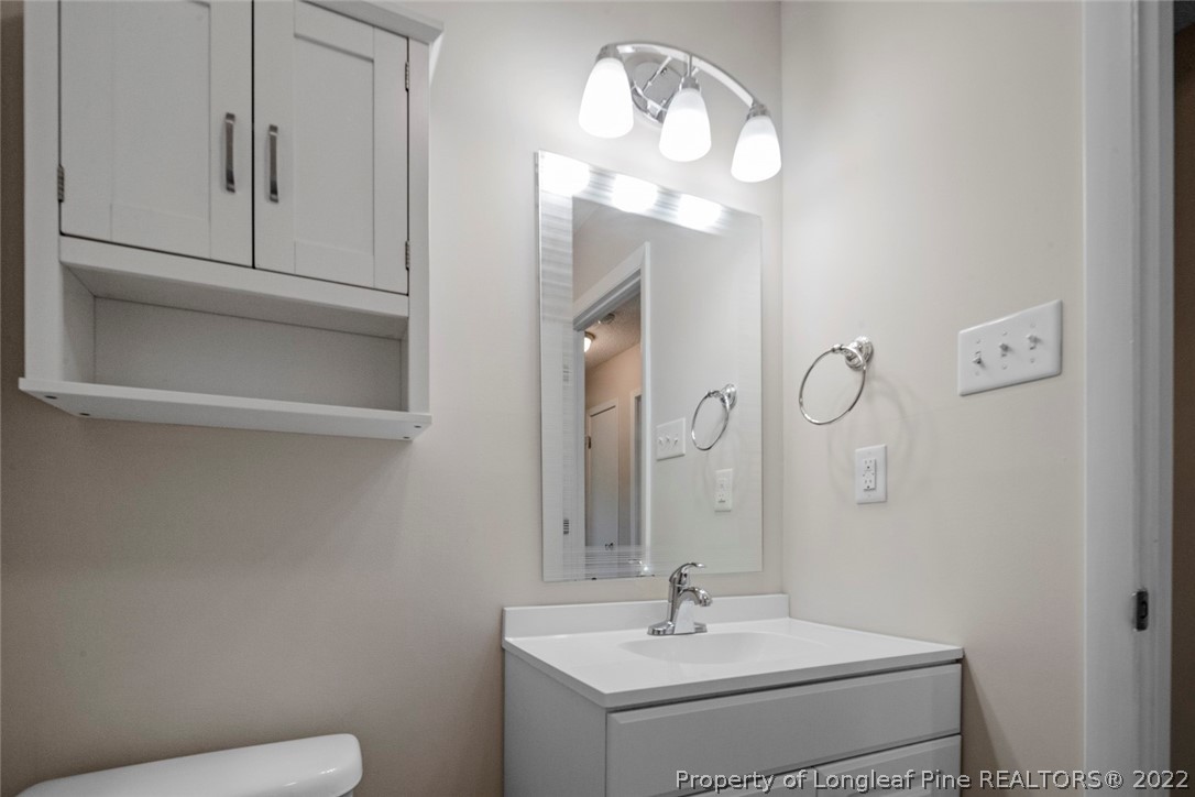 6614 Wake Forest Road Fayetteville, NC 28311 - Photo 33 of 48 a bathroom with a sink and a mirror