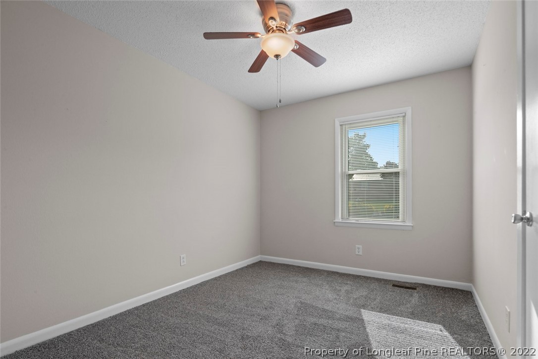 6614 Wake Forest Road Fayetteville, NC 28311 - Photo 34 of 48 an empty room with windows and fan