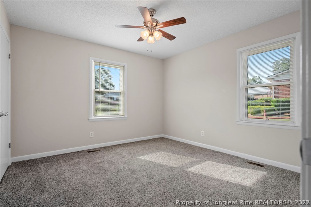 6614 Wake Forest Road Fayetteville, NC 28311 - Photo 36 of 48 an empty room with windows and fan