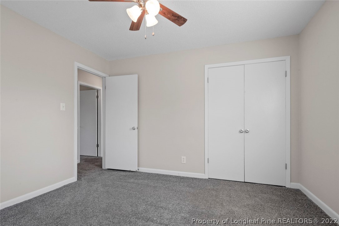 6614 Wake Forest Road Fayetteville, NC 28311 - Photo 37 of 48 an empty room with a chandelier fan