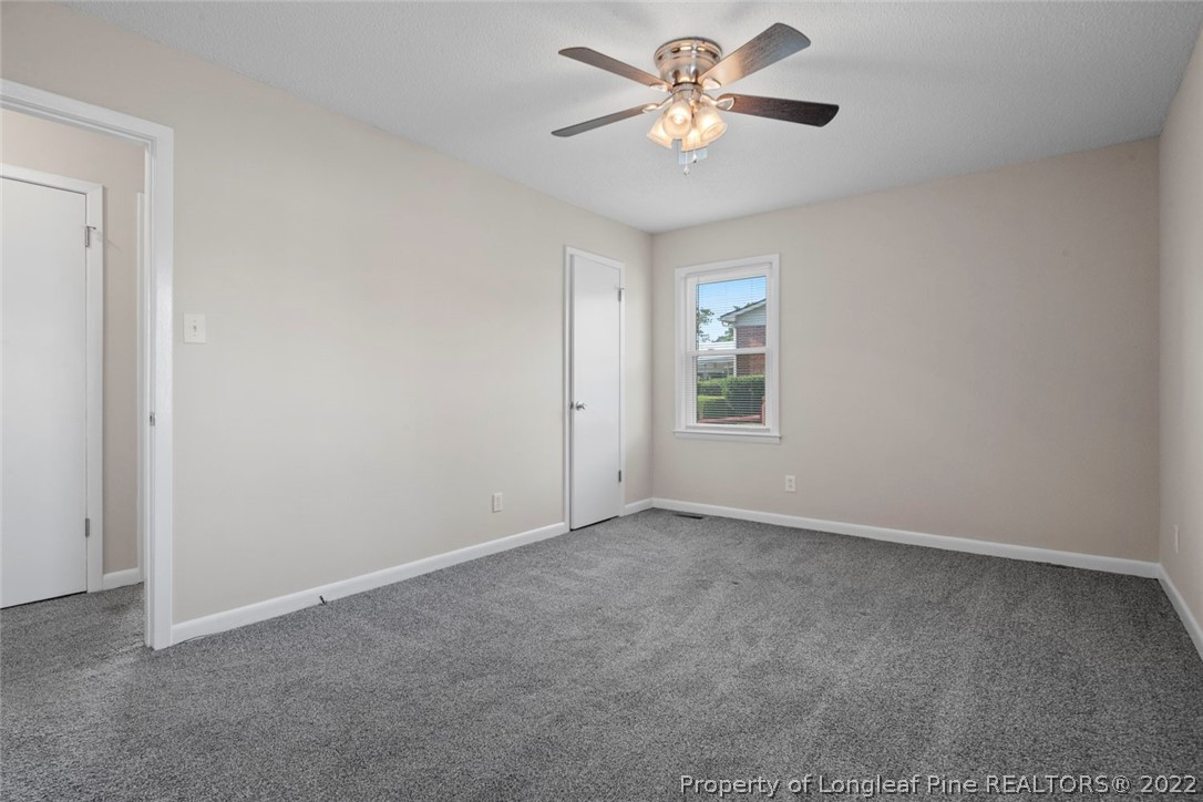 6614 Wake Forest Road Fayetteville, NC 28311 - Photo 39 of 48 an empty room with a window and a fan