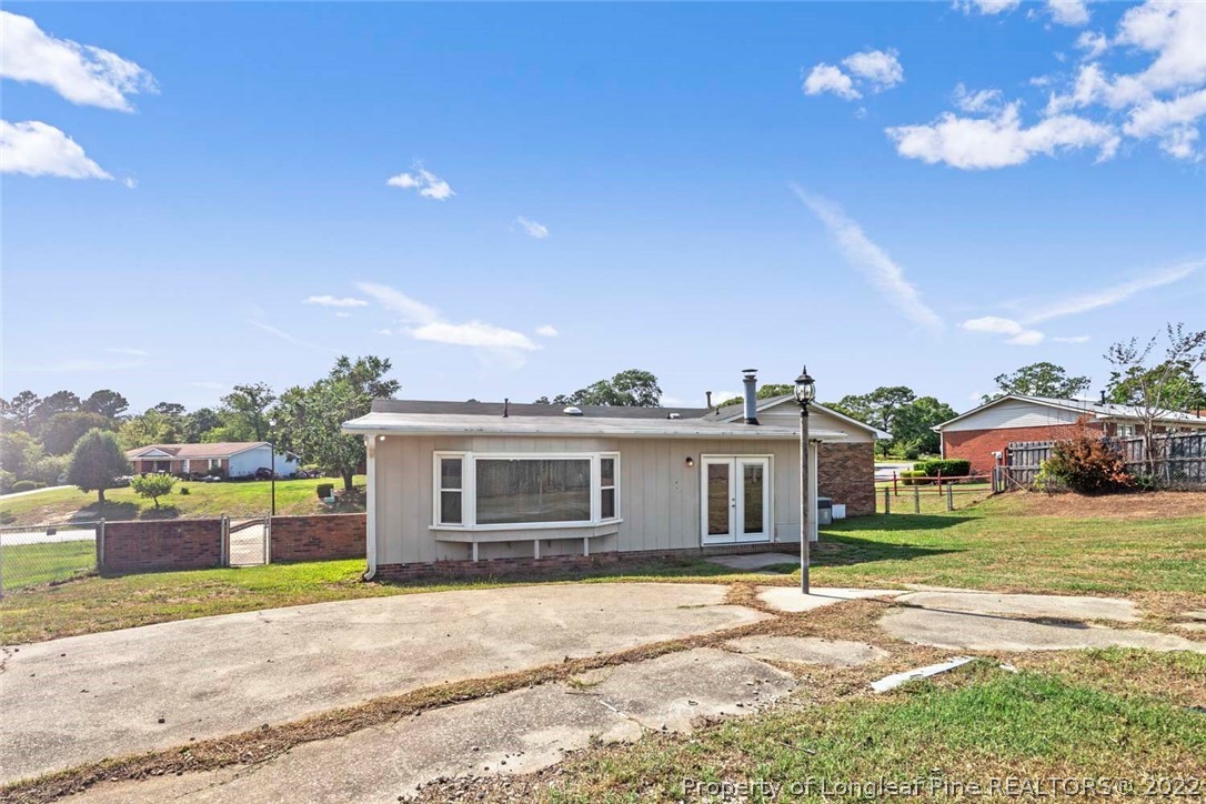 6614 Wake Forest Road Fayetteville, NC 28311 - Photo 46 of 48 a front view of a house with a garden and trees