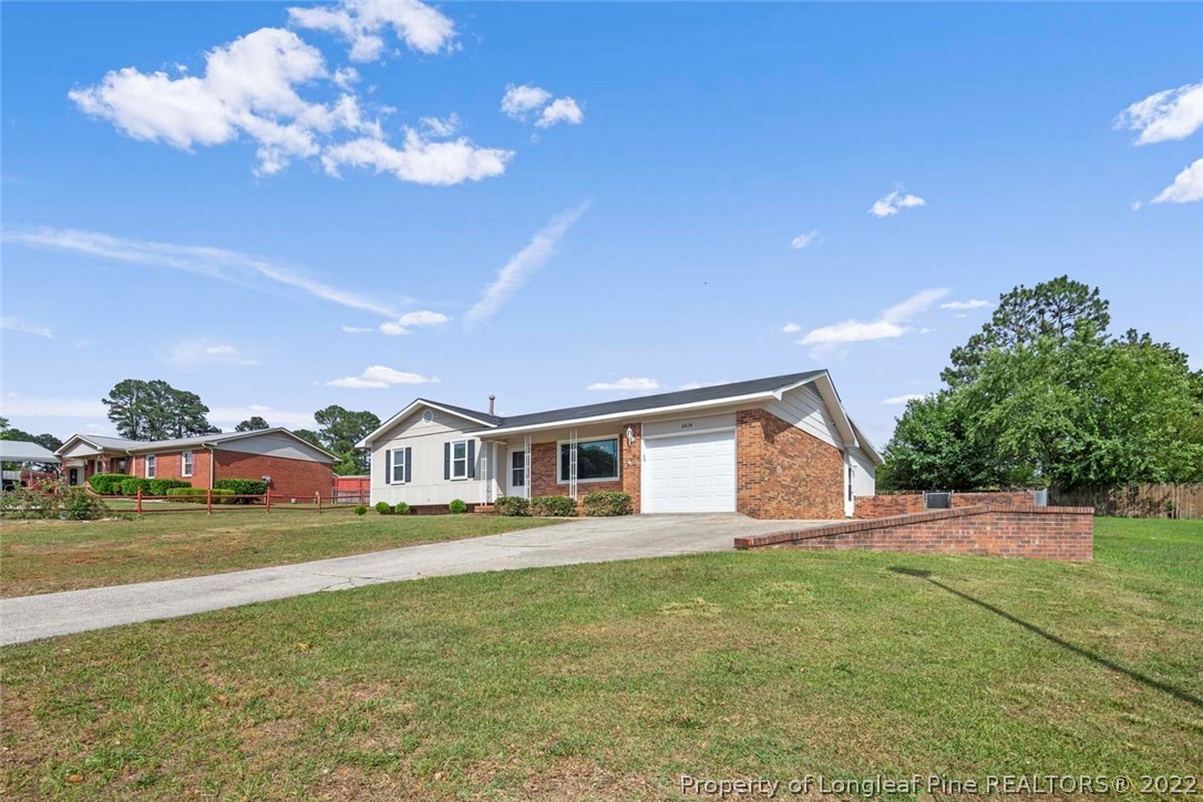 6614 Wake Forest Road Fayetteville, NC 28311 - Photo 5 of 48 a view of a house with a big yard