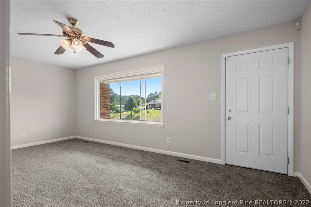 6614 Wake Forest Road Fayetteville, NC 28311 - Photo 10 of 48 an empty room with windows and fan