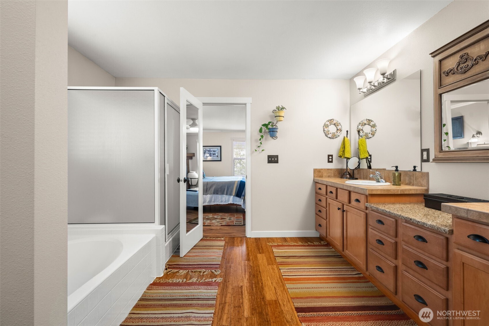3114 Walker Road DuPont, WA 98327 - Photo 22 of 38 a spacious bathroom with a double vanity sink a mirror and a bathtub